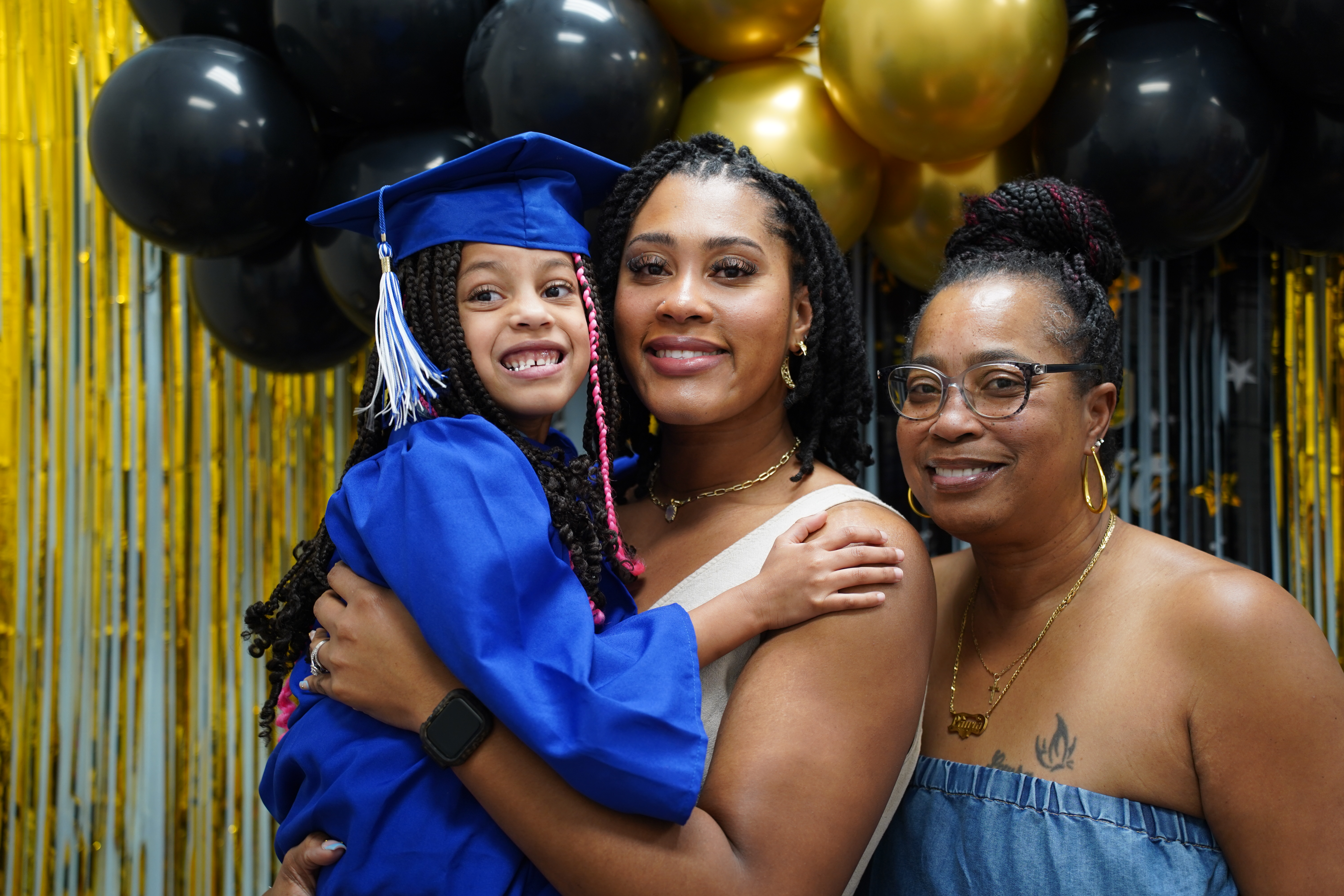 Family celebrating a child's graduation milestone at Behavioral Innovations